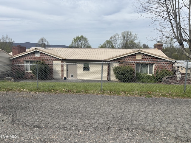 490 Delaney Ln, Clintwood, VA 24228 - view of front of home featuring brick siding, metal roof, a chimney, and fence