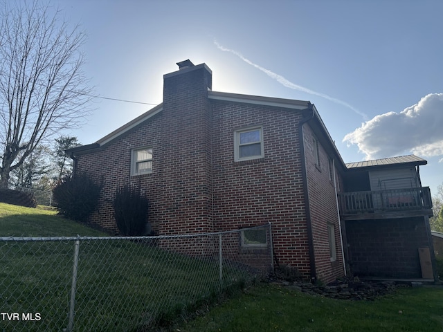 490 Delaney Ln, Clintwood, VA 24228 - view of property exterior with a lawn, brick siding, and a balcony