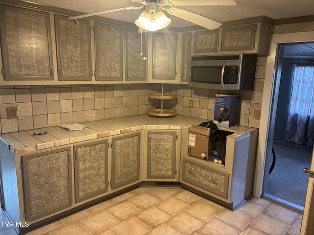 490 Delaney Ln, Clintwood, VA 24228 - kitchen with tile countertops, stainless steel microwave, and decorative backsplash