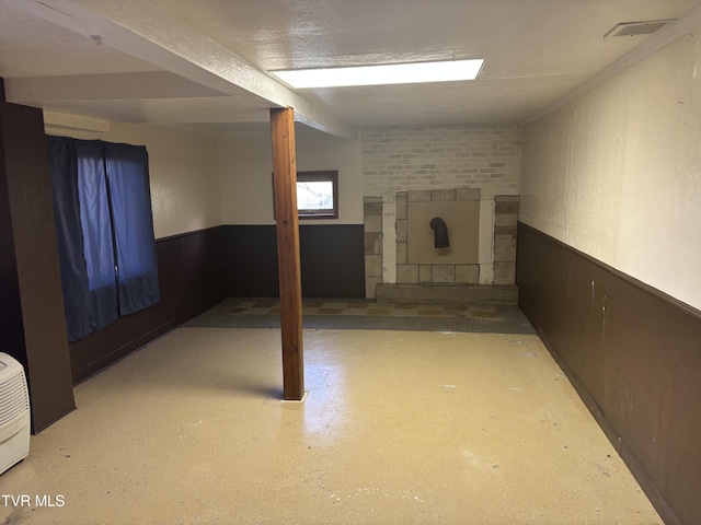 490 Delaney Ln, Clintwood, VA 24228 - finished below grade area featuring a fireplace, visible vents, and a wainscoted wall