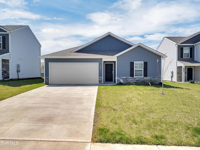 1245 Cherry Grv, Greeneville, TN 37745 - view of front of home with a garage, stone siding, concrete driveway, a front yard, and roof with shingles