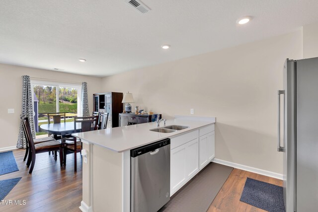 1245 Cherry Grv, Greeneville, TN 37745 - kitchen with stainless steel appliances, a sink, a peninsula, white cabinetry, and light countertops