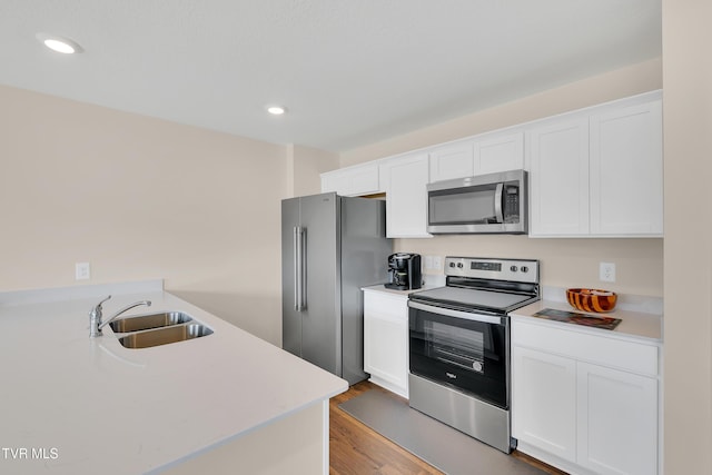 1245 Cherry Grv, Greeneville, TN 37745 - kitchen featuring stainless steel appliances, a sink, light countertops, white cabinetry, and recessed lighting