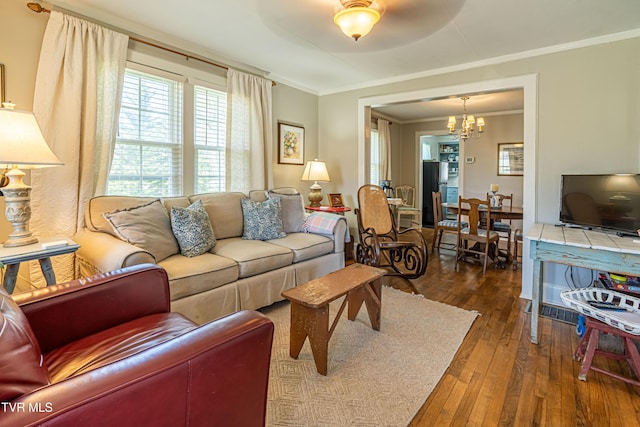 313 SE Tanner St, Abingdon, VA 24210 - living room with dark wood-style flooring, ornamental molding, and an inviting chandelier