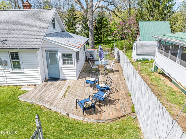 313 SE Tanner St, Abingdon, VA 24210 - wooden deck featuring a fenced backyard, a sunroom, a lawn, and outdoor dining area