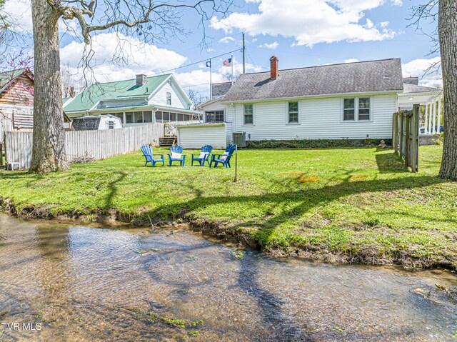 313 SE Tanner St, Abingdon, VA 24210 - rear view of house featuring a lawn, central AC unit, a chimney, and fence