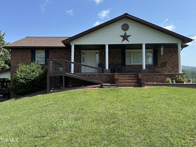 1456 Osbornes Gap Rd, Clintwood, VA 24228 - view of front facade with brick siding, covered porch, and a front lawn