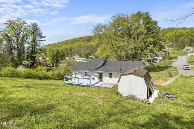 1219 Ledford St, Elizabethton, TN 37643 - rear view of property featuring a yard, a wooden deck, and a wooded view
