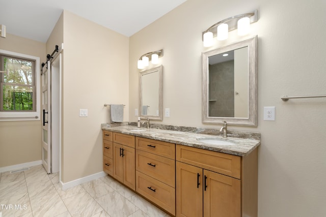 332 Tom Patterson Trl, Dandridge, TN 37725 - bathroom featuring marble look tile flooring, double vanity, and baseboards