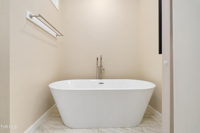 332 Tom Patterson Trl, Dandridge, TN 37725 - full bathroom with marble look tiles, a soaking tub, and baseboards