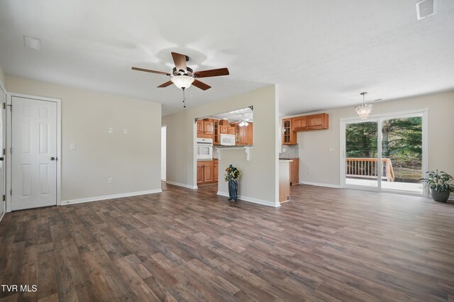 536 Chadwell Rd, Kingsport, TN 37660 - unfurnished living room with dark wood finished floors, visible vents, baseboards, and ceiling fan with notable chandelier