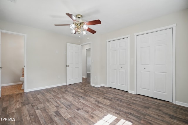536 Chadwell Rd, Kingsport, TN 37660 - unfurnished bedroom with baseboards, multiple closets, and wood finished floors