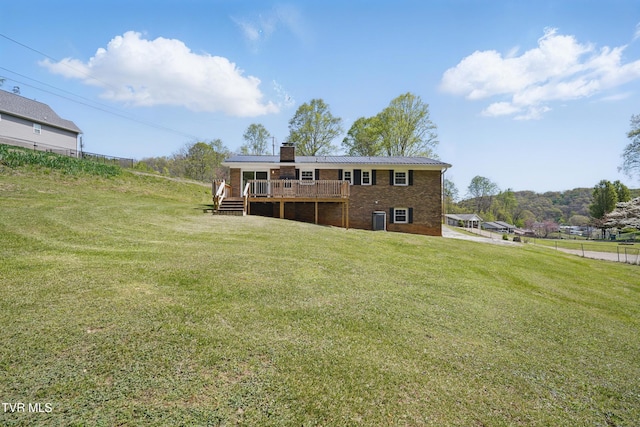 536 Chadwell Rd, Kingsport, TN 37660 - back of house featuring central AC unit, a chimney, metal roof, a lawn, and a deck