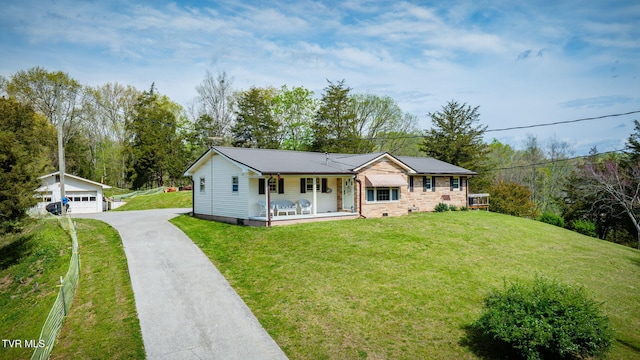 ranch-style home featuring crawl space, a front lawn, an outdoor structure, and a detached garage