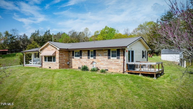 view of front of house featuring crawl space, a wooden deck, a front yard, and metal roof