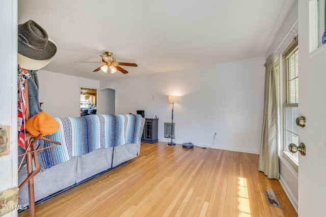 unfurnished bedroom with baseboards, hardwood / wood-style flooring, visible vents, and ceiling fan
