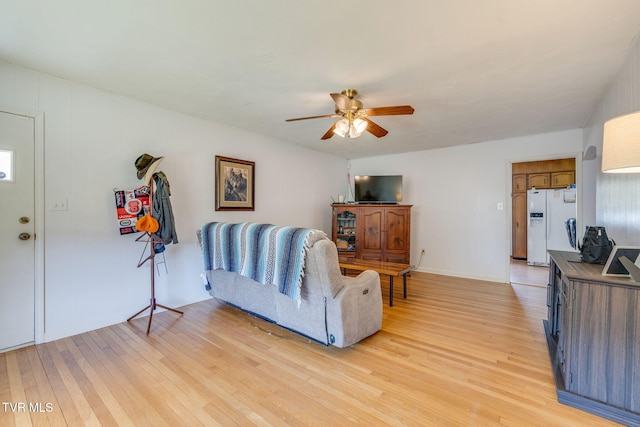 living room with light wood-type flooring and ceiling fan