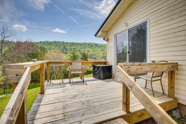 wooden deck featuring a view of trees