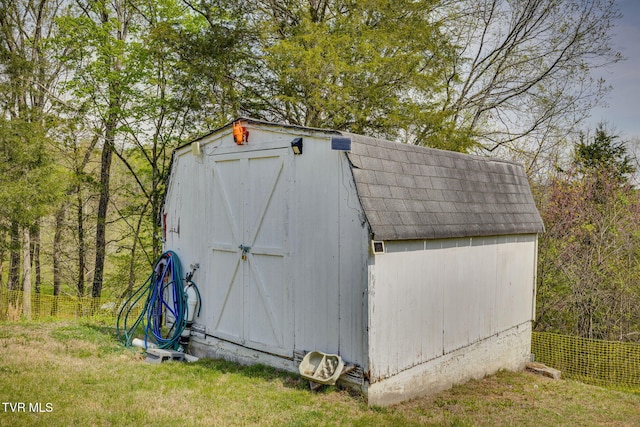 view of shed with fence