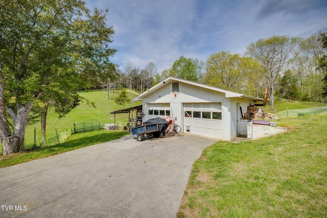 exterior space with fence, a garage, and a front yard