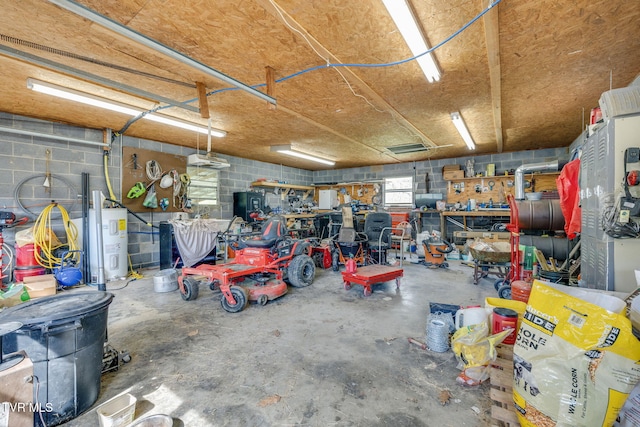 garage with water heater, a workshop area, and concrete block wall