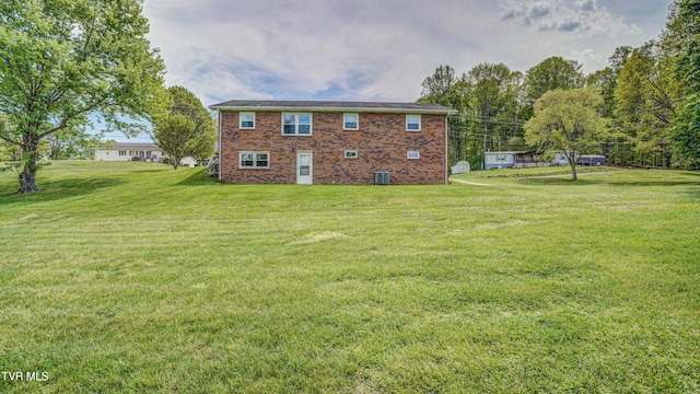 683 Ridge Rd, Piney Flats, TN 37686 - rear view of property with brick siding, central AC unit, and a yard
