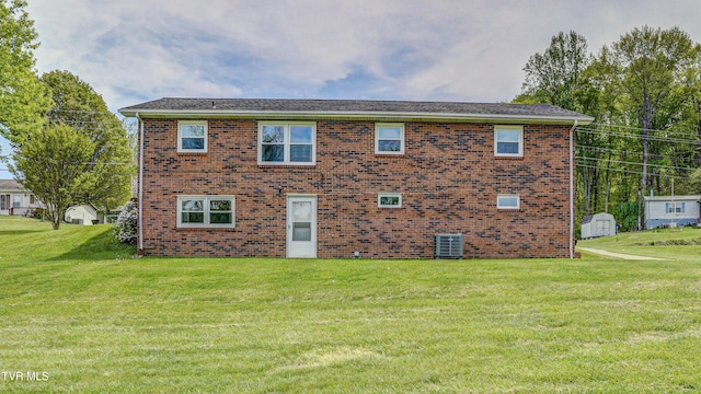 683 Ridge Rd, Piney Flats, TN 37686 - view of front of home with central AC unit, a front yard, and brick siding