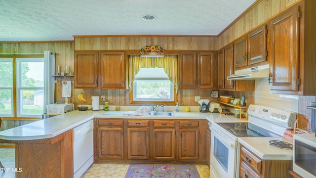 683 Ridge Rd, Piney Flats, TN 37686 - kitchen featuring a textured ceiling, a peninsula, under cabinet range hood, and white appliances