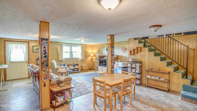 683 Ridge Rd, Piney Flats, TN 37686 - living room with wooden walls, stairs, and a textured ceiling