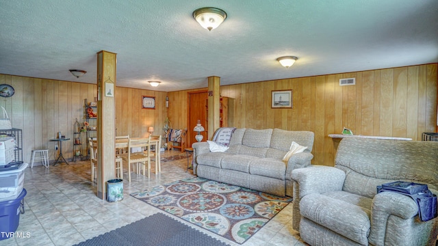 683 Ridge Rd, Piney Flats, TN 37686 - living area featuring wood walls, a textured ceiling, and visible vents