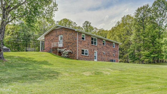 683 Ridge Rd, Piney Flats, TN 37686 - view of home's exterior with brick siding, cooling unit, and a lawn