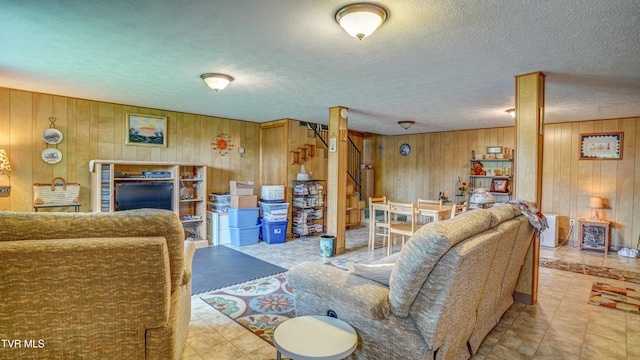 683 Ridge Rd, Piney Flats, TN 37686 - living room featuring wood walls and a textured ceiling