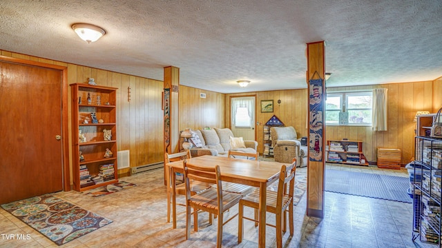 683 Ridge Rd, Piney Flats, TN 37686 - dining area featuring tile patterned floors, baseboard heating, visible vents, and wooden walls