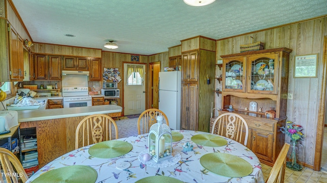 683 Ridge Rd, Piney Flats, TN 37686 - dining space with wood walls, a textured ceiling, and ornamental molding