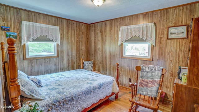 683 Ridge Rd, Piney Flats, TN 37686 - bedroom with wooden walls, crown molding, a textured ceiling, and wood finished floors