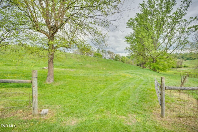 view of yard featuring a rural view and fence