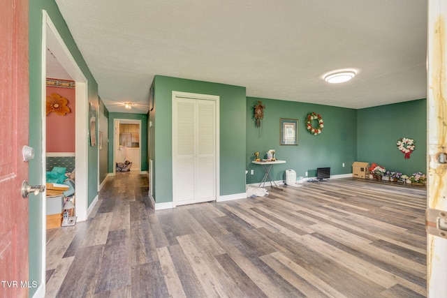 playroom featuring baseboards and wood finished floors