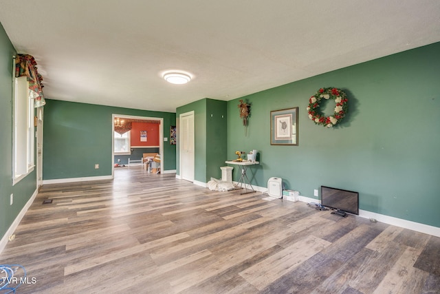 interior space featuring baseboards and wood finished floors