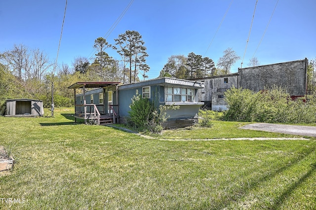 4418 Weaver Pike, Bluff City, TN 37618 - rear view of house with an outdoor structure, a yard, and a shed
