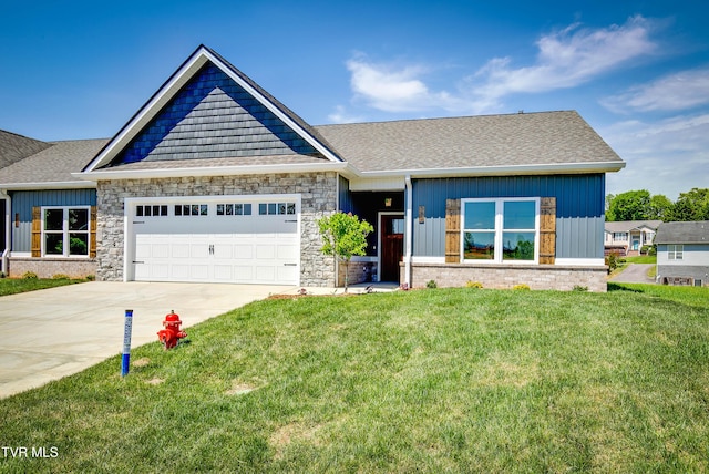 craftsman inspired home with stone siding, concrete driveway, an attached garage, a shingled roof, and a front yard