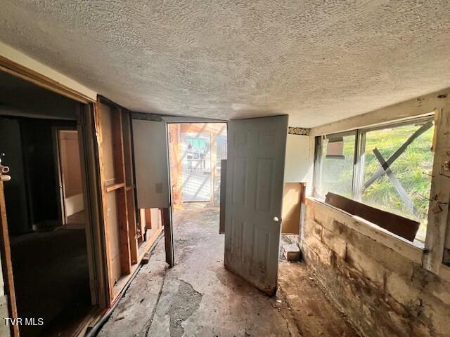 miscellaneous room with a textured ceiling