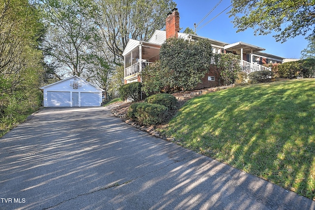344 Virginia Dr, Bristol, VA 24201 - view of property exterior featuring a detached garage, an outbuilding, a chimney, and a lawn