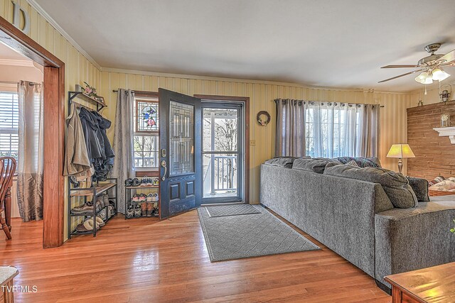 344 Virginia Dr, Bristol, VA 24201 - living room featuring wood walls, ceiling fan, wood finished floors, and ornamental molding