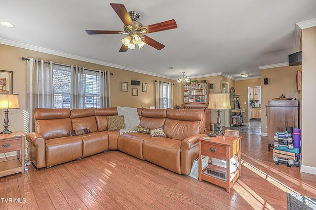 344 Virginia Dr, Bristol, VA 24201 - living room with light wood-style floors, baseboards, ornamental molding, and ceiling fan with notable chandelier