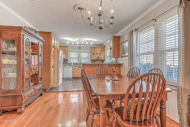 344 Virginia Dr, Bristol, VA 24201 - dining room featuring light wood-type flooring, an inviting chandelier, and ornamental molding