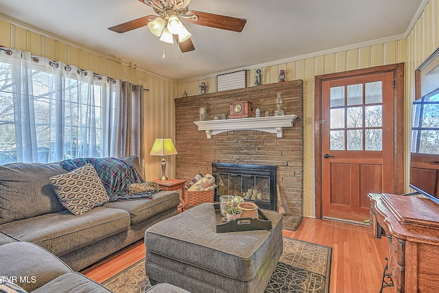 344 Virginia Dr, Bristol, VA 24201 - living room with crown molding, a ceiling fan, wood finished floors, a fireplace, and wood walls