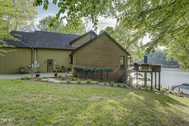 768 Lake Point Dr, Piney Flats, TN 37686 - rear view of house with a shingled roof, a patio, a water view, and a lawn