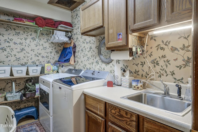 768 Lake Point Dr, Piney Flats, TN 37686 - laundry room with washer and clothes dryer, a sink, cabinet space, and wallpapered walls