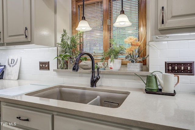 768 Lake Point Dr, Piney Flats, TN 37686 - kitchen with hanging light fixtures, light countertops, tasteful backsplash, and a sink