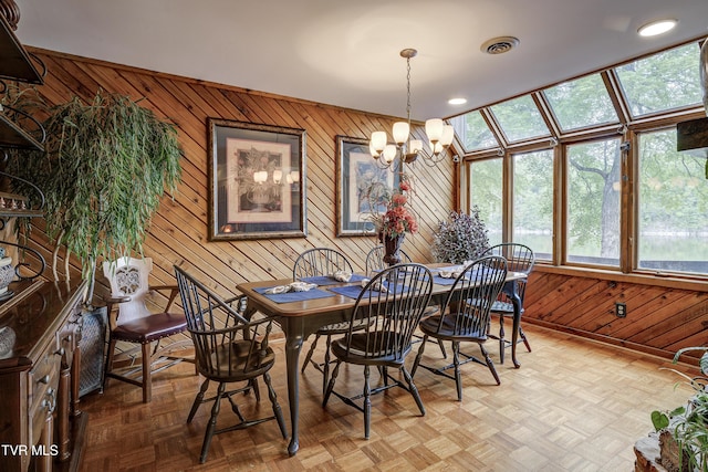768 Lake Point Dr, Piney Flats, TN 37686 - dining space featuring a wealth of natural light, wood walls, an inviting chandelier, and visible vents